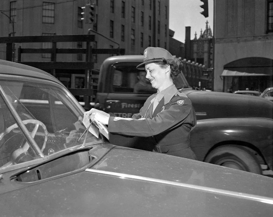 #114 New policewoman Martha S. Jackson placed one of her first tickets on an illegally parked car, 1952.