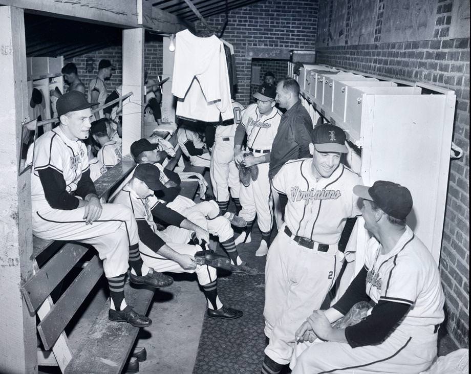 #20 Members of the Richmond Virginians engaged in a pre-practice bull session in their locker room, 1955.