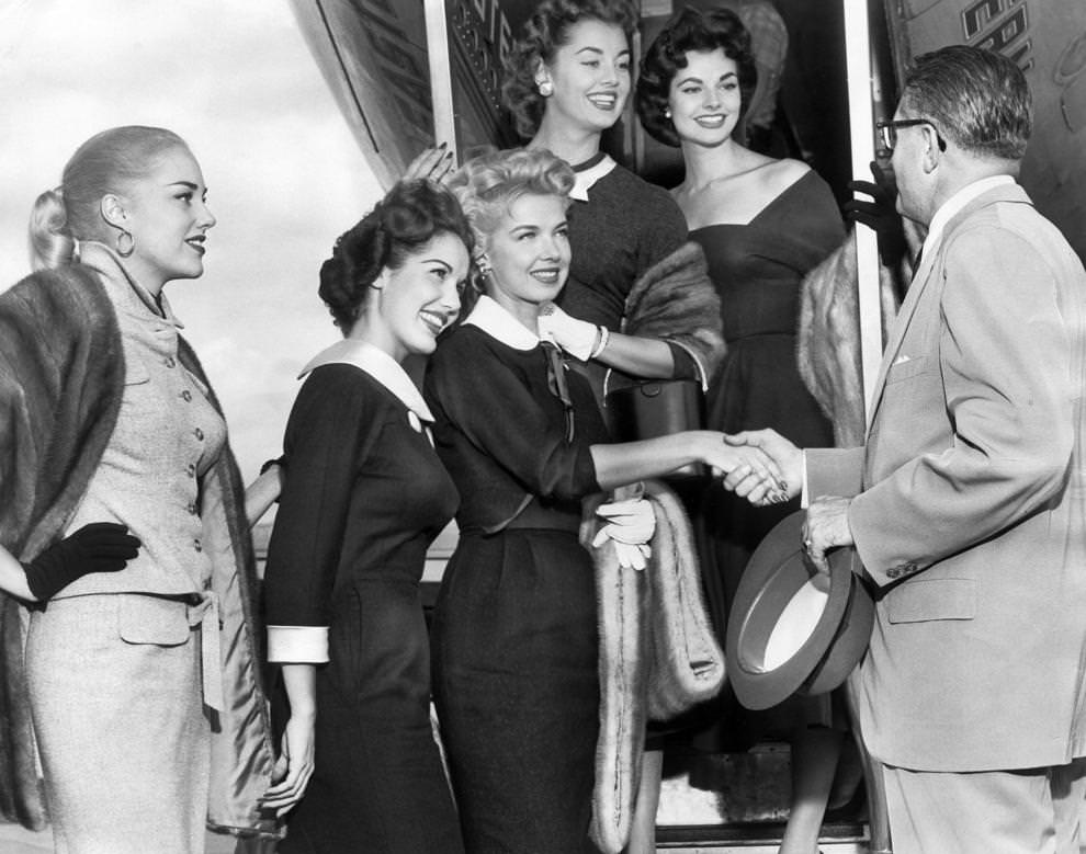 #220 Five members of the Goldwyn Girls, who made an appearance in Richmond during the National Tobacco Festival, bid farewell to a local representative, 1955.