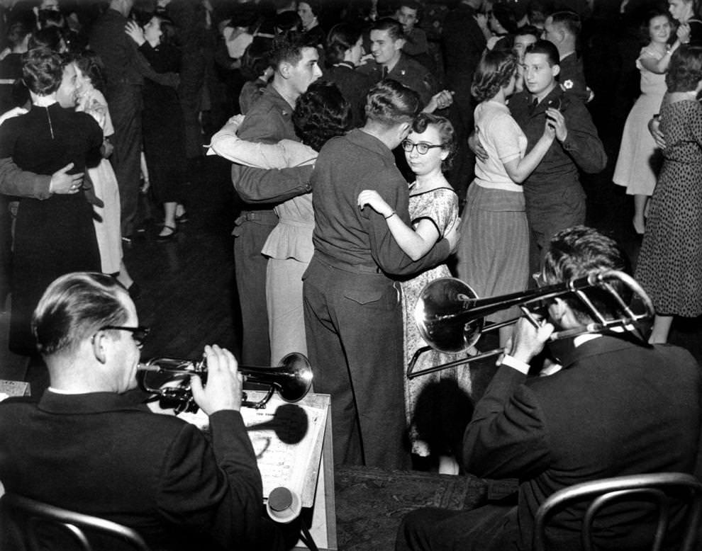 #238 Hundreds of dancers crowded the floor of the Winter Garden at the Hotel Richmond to mark the first anniversary of a series of Saturday night hotel dances for military members, 1951.