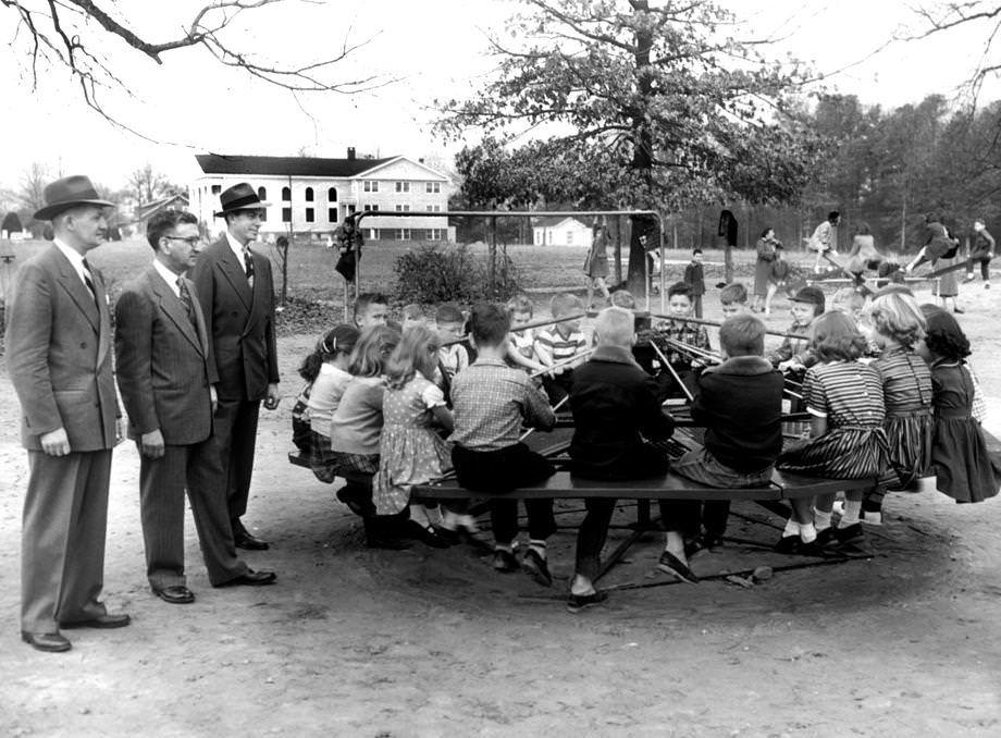 #29 The new whirlaway, a merry-go-round type of gadget turned by the foot power of dozens of students, was popular at Dumbarton Elementary School in Henrico County, 1953.