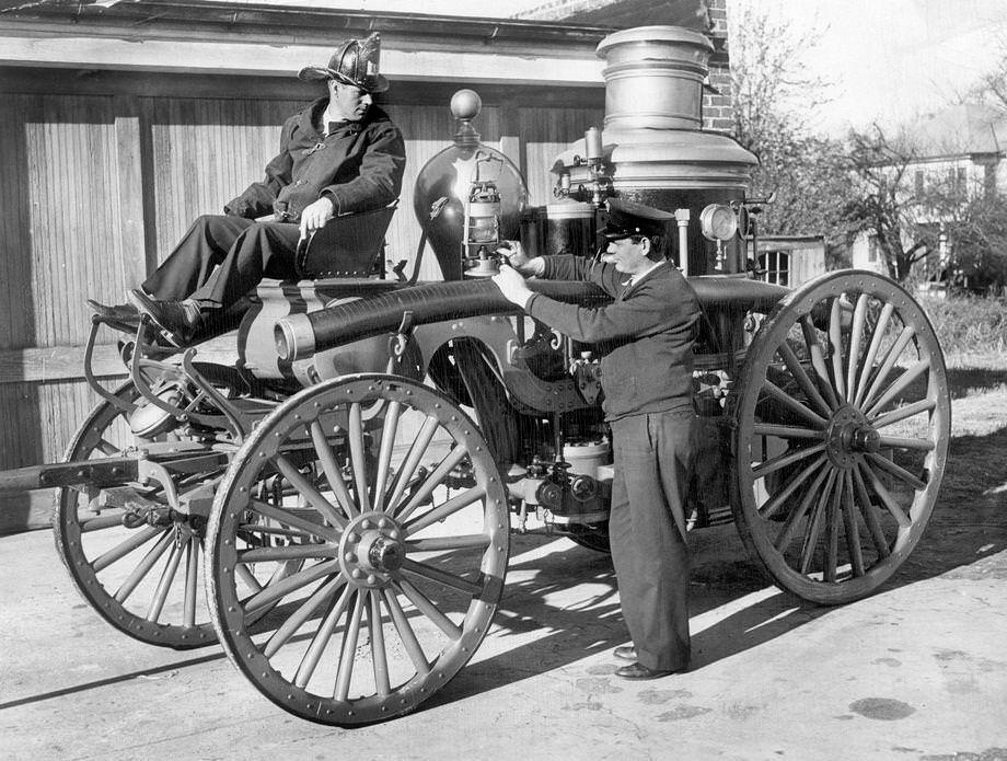 #40 Firemen W.M. Alley and J.B. Winston mounted Richmond’s oldest fire engine, Old 798.