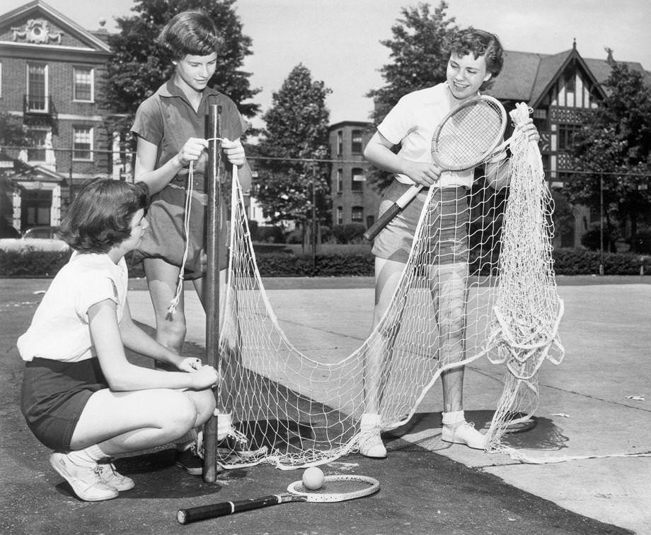 #72 Barbara Kilday (from left), Becky Branch and Jill Arnold set up a net for tennis, 1950. The 14-year-olds were attending summer school in the Richmond area.