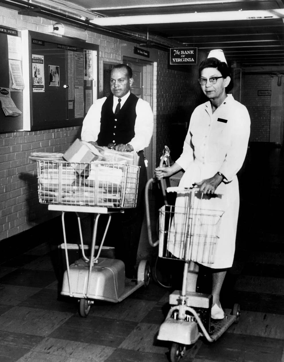 #94 Charles W. Sykes and Freda S. Daniel of the McGuire Veterans Administration Hospital in Richmond used battery-powered scooters to take them from ward to ward, 1965.