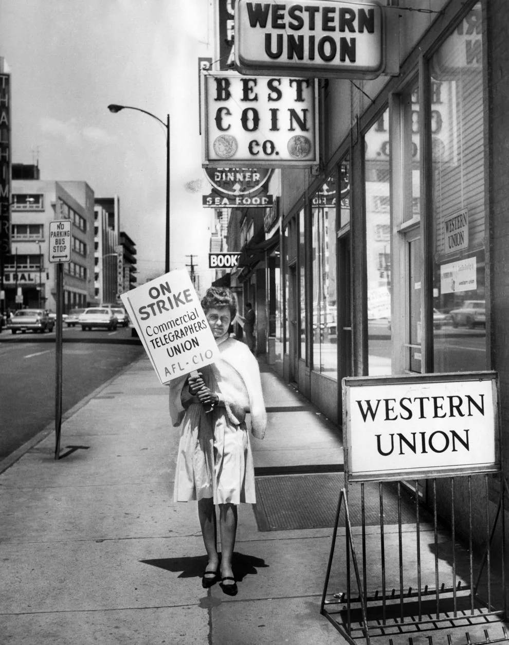 #114 A woman picketed in front of a Western Union office in Richmond, 1966.