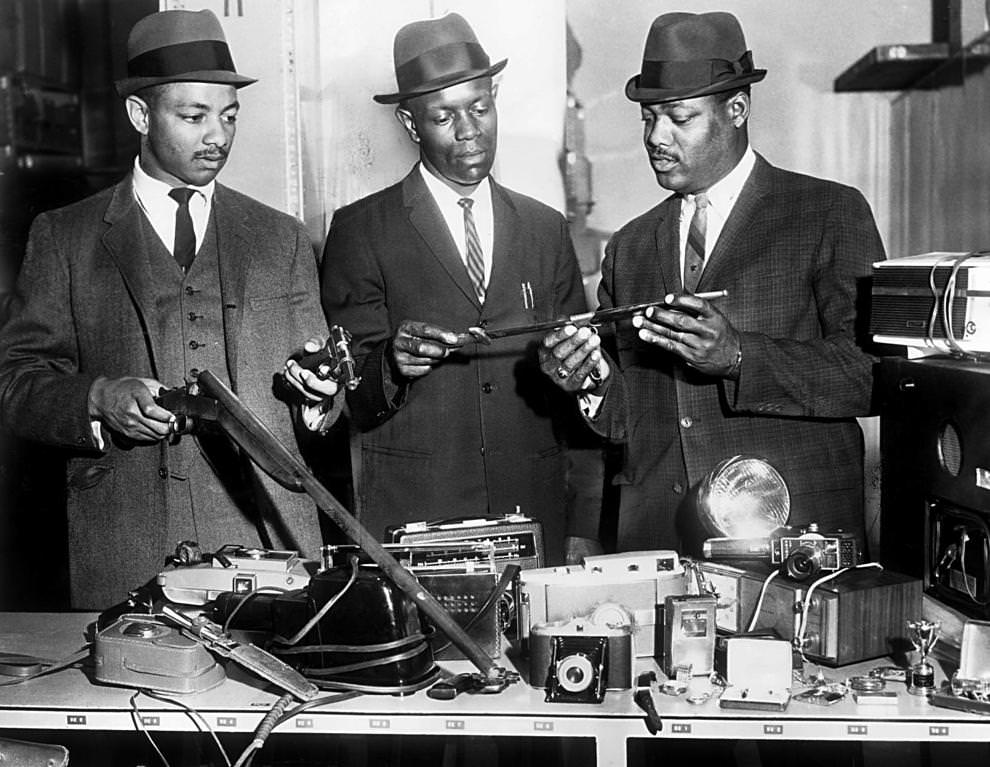 #120 Richmond police officers (from left) Christopher Stokes, John W. Harris and H.L. Coleman reviewed items recovered from a series of North Side burglaries, 1966.