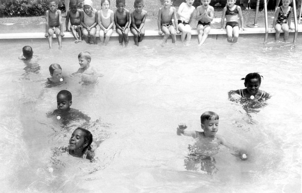 #135 Children from the Follow Through program at the Ginter Park Presbyterian Church in Richmond demonstrated their swimming skills by directing ping pong balls across the pool, 1960.