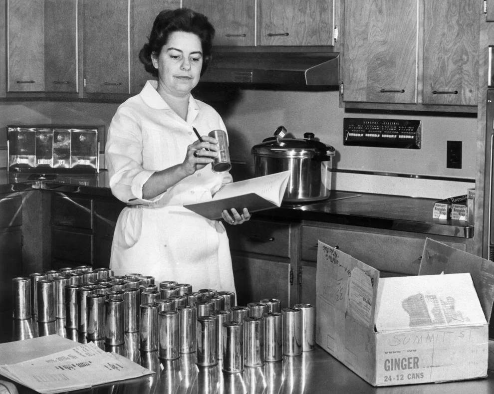 #153 Mrs. William Cox recorded numbers from sample cans at a Reynolds Metals Co. test kitchen in Richmond, 1962.