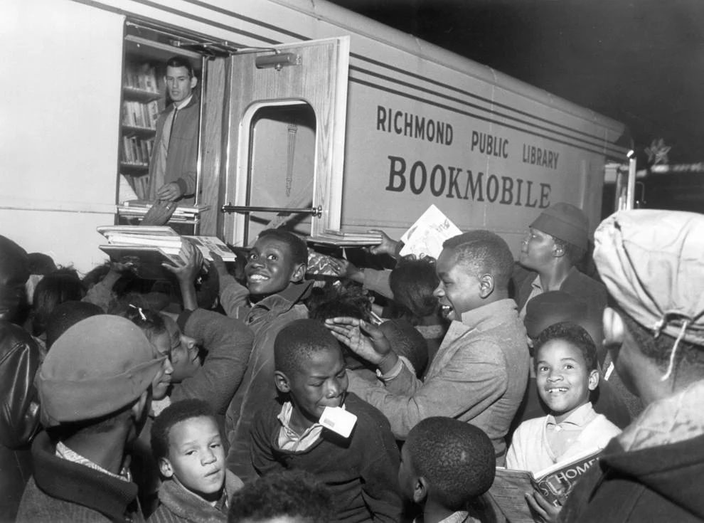 #157 Children crowded the bookmobile when it stopped at 25th and Q streets in Richmond’s East End, 1962.