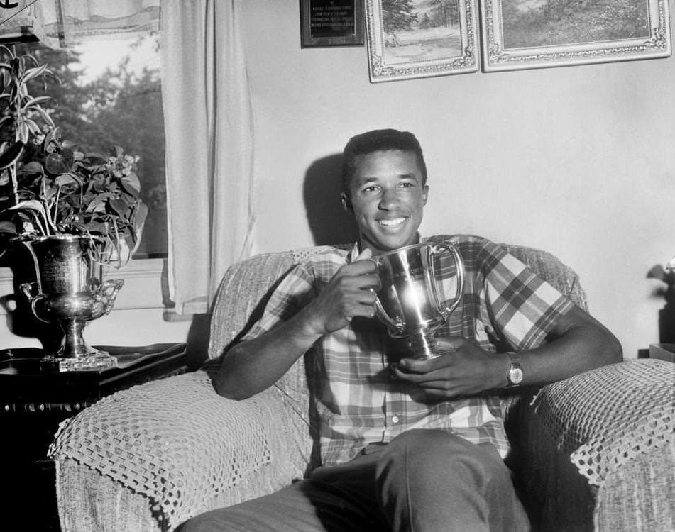 #158 Tennis star Arthur Ashe Jr. admired his Eastern Grass Court Championship trophy at his home on Aug. 10, 1964.