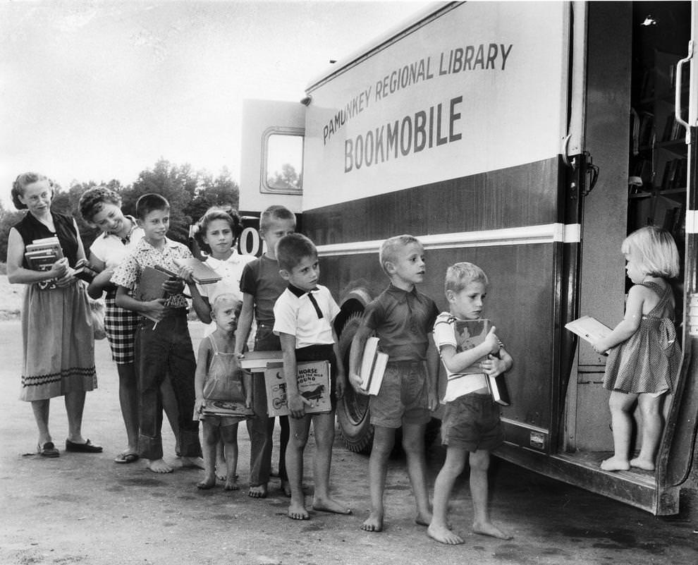 #19 Mrs. S.A. Rhyne and nine of her 11 children lined up at the Pamunkey Regional Library’s bookmobile, 1961.