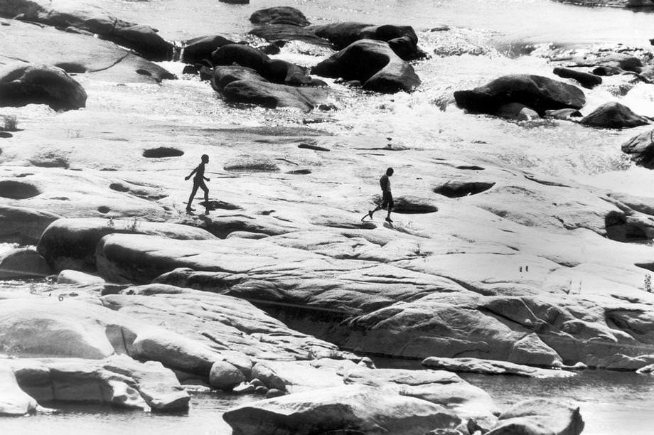 #7 Two boys walked along the rocks in the James River near the Lee Bridge in Richmond, 1979.