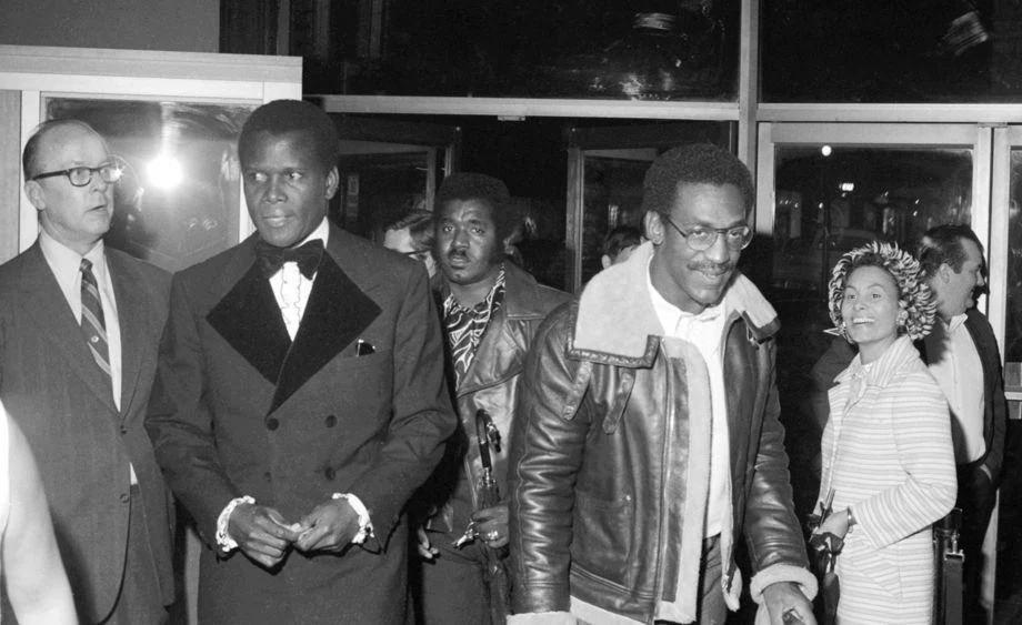 #122 Sidney Poitier (left) and Bill Cosby entered the Loew’s Theater for a benefit to raise money to rebuild Virginia Union University’s Coburn Chapel, which burned in 1970.