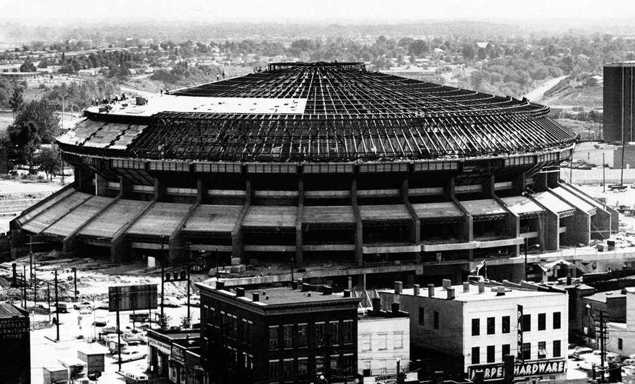 #151 With the superstructure for the roof of Richmond’s coliseum inb place, workmen are busy putting the roofing on the massive structure, 1970