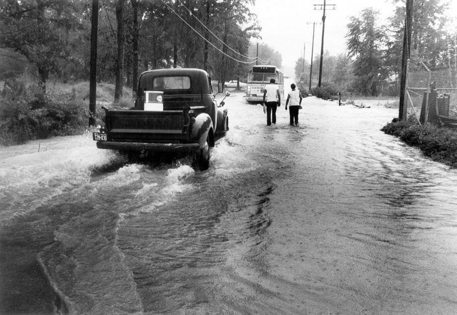 #180 Overflow from Reedy Creek flooded German School Road in South Richmond, 1970.