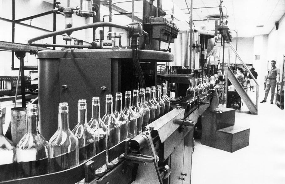 #181 Bottles on an assembly line waited to be filled with Virginia Gentleman bourbon at the A. Smith Bowman Distillery in Reston in Fairfax County, 1970.