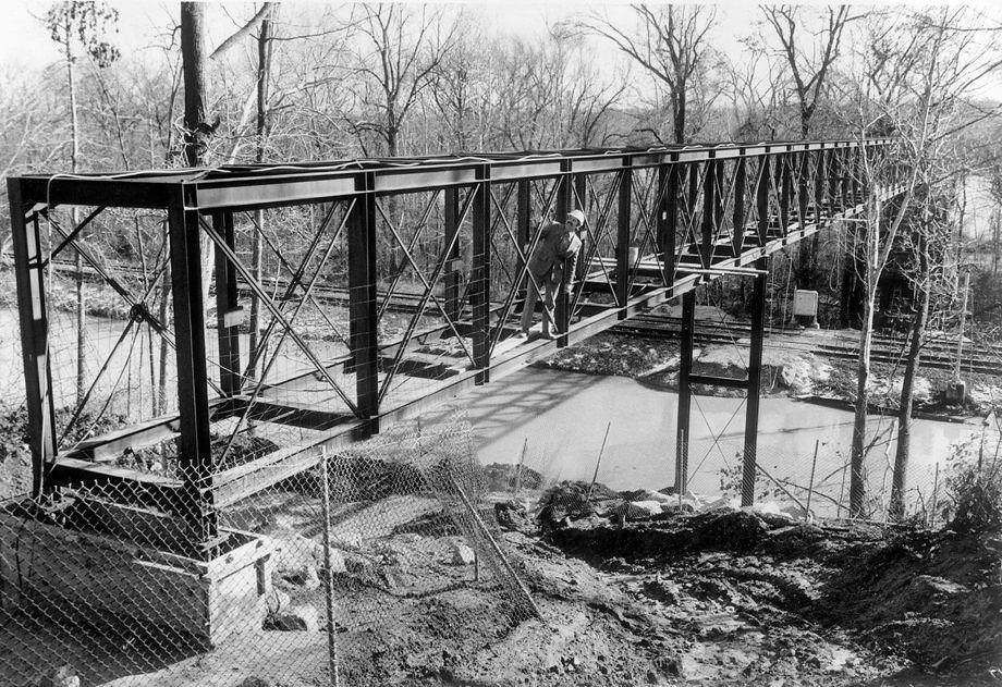 #29 Bill Heindl, a co-founder of the Heindl-Evans Inc. construction firm, oversaw progress on building a footbridge in James River Park at Texas Avenue in Richmond, 1978.