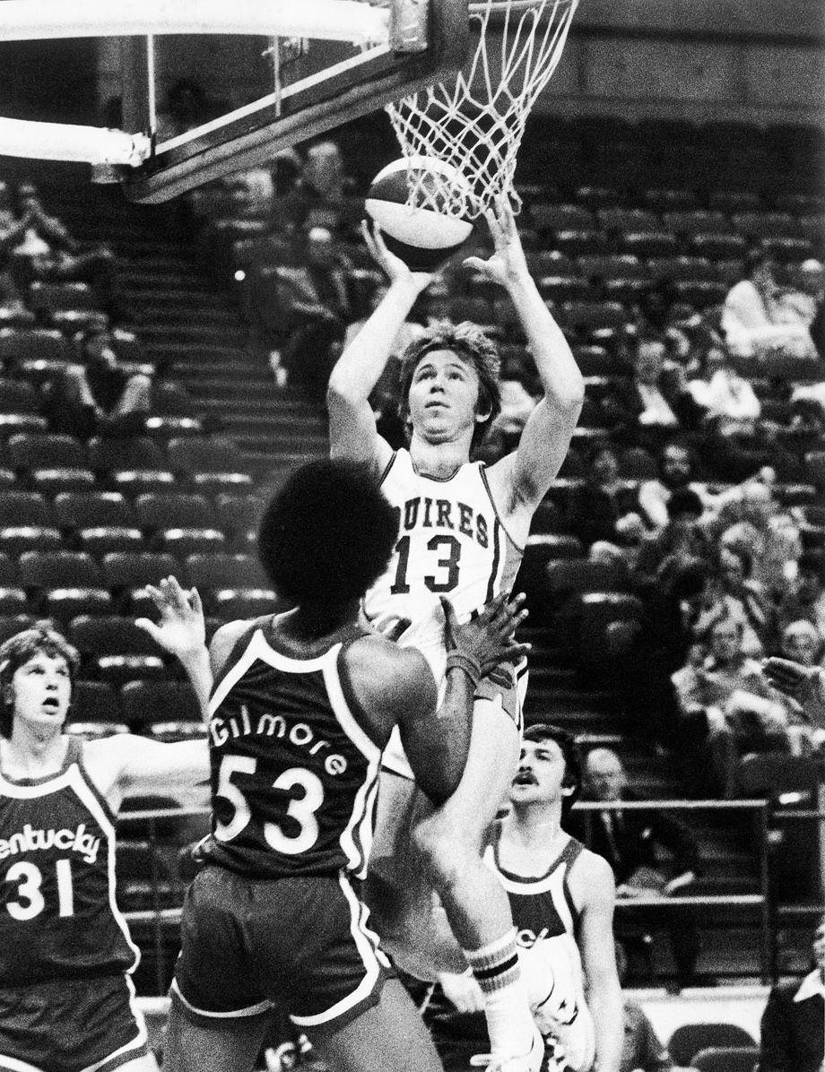 #39 Dave Twardzik of the Squires shot over Artis Gilmore of the Kentucky Colonels en route to a Squires victory before a crowd of only 1,017 at the Coliseum, 1976.