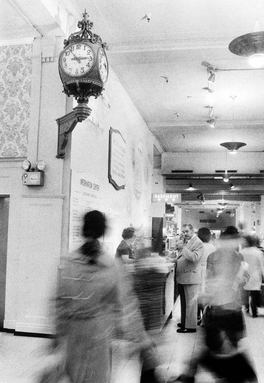 #64 Shoppers passed by “the clock” at Miller & Rhoads in downtown Richmond, 1975.