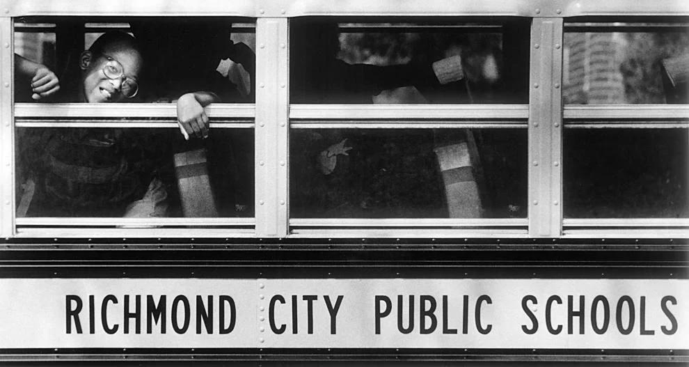 #82 Corey Green peeked out the school bus window on his way home after the first day of school at John B. Cary Elementary School in Richmond, 1985