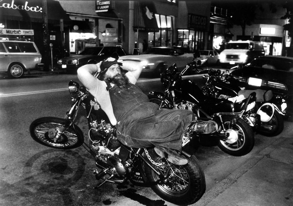 #84 Tom Thomas kicked back on his Harley-Davidson outside Newgate Prison, a bar in the 900 block of West Grace Street in Richmond, 1985