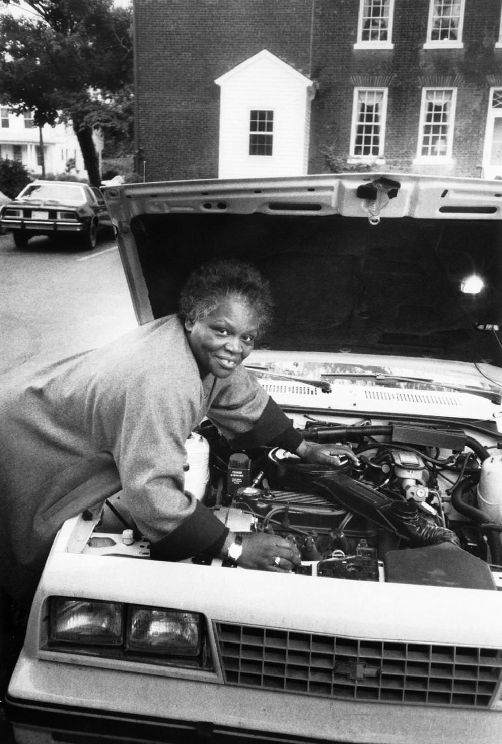 #115 Hilda West worked on a car in Fredericksburg, where she had addressed an apprenticeship conference, 1986