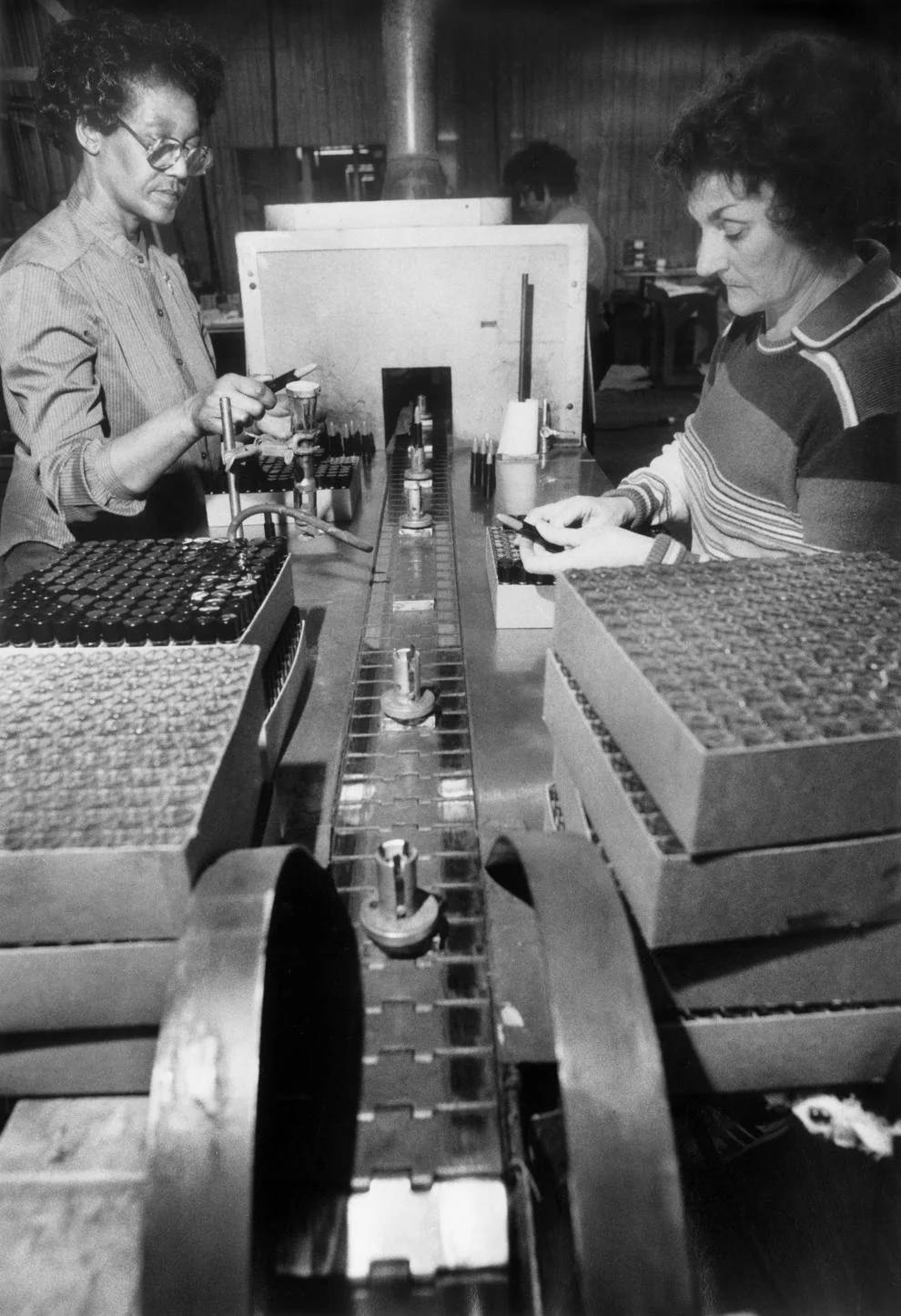 #64 Mildred Ashton (left) and Elva Jones glazed lipstick on the assembly line at the A.R. Winarick cosmetics manufacturing plant in Westmoreland County, 1985.