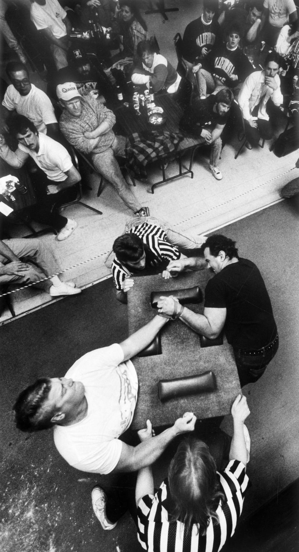 #15 Tracy Ward (left) and John Ottarski squared off in the left-handed competition at the Virginia Classic Arm Wrestling Championship, held at Joe’s Place in Petersburg, 1991