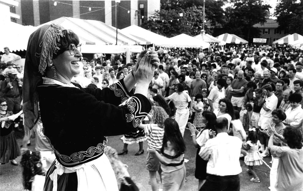 #31 Rena Tsengas leads the beat from the stage while patrons dance in front of the large crowd at the 1992 Greek Festival in Richmond, Va. on May 31.