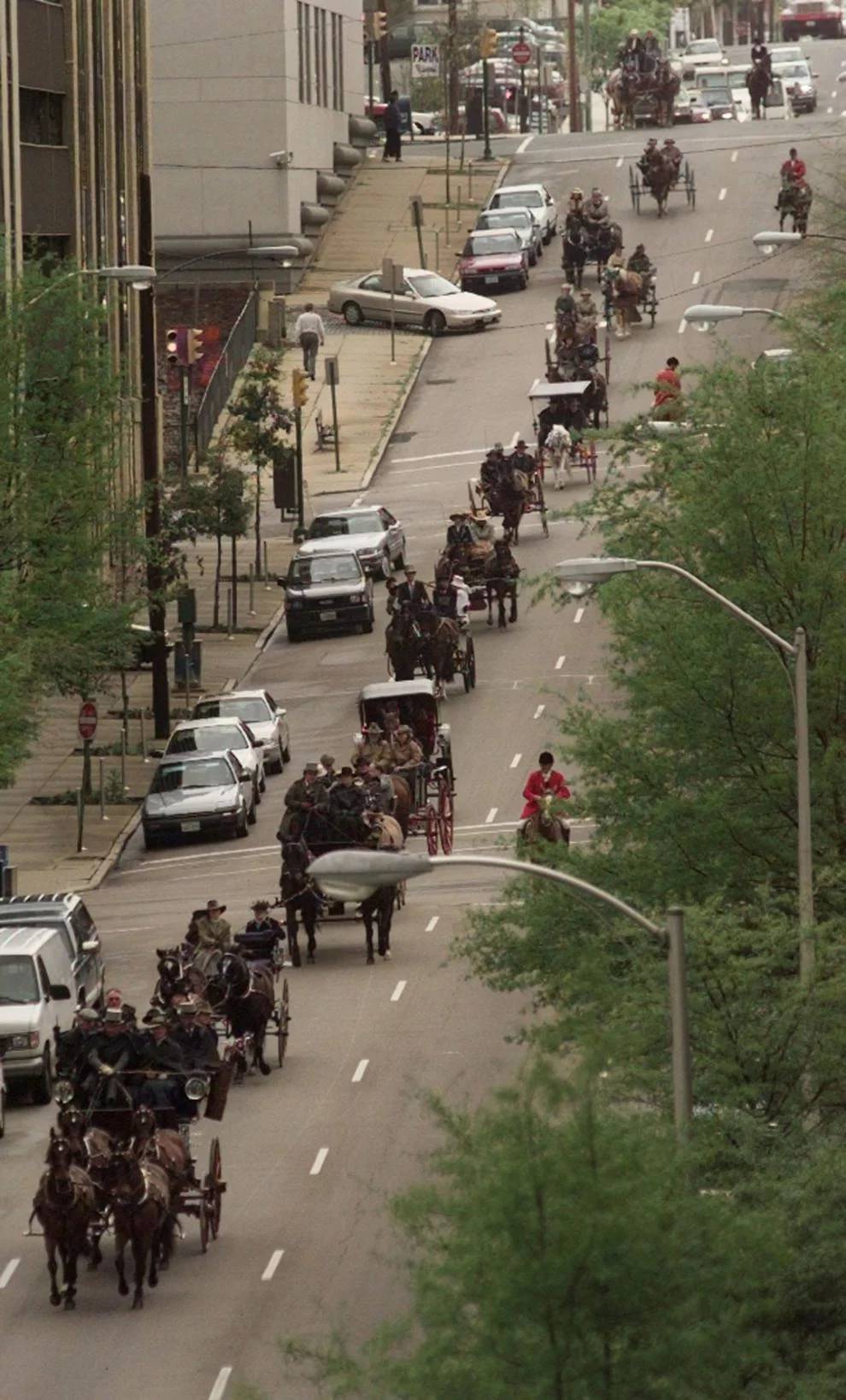 #40 A line of carriages rolls down Cary Street on its way to the Capitol to kick off the Strawberry Hills Races this weekend. April 10, 1998