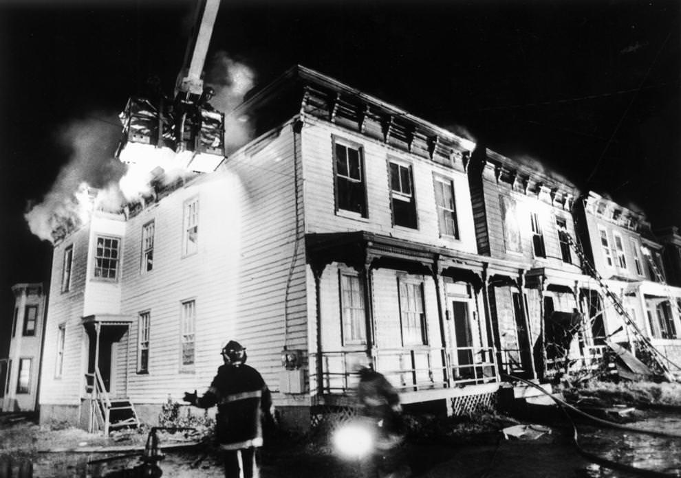 #45 A city Fire Bureau aerial ladder truck poured water onto the flaming row houses in 16-degree temperatures last night, 1992.