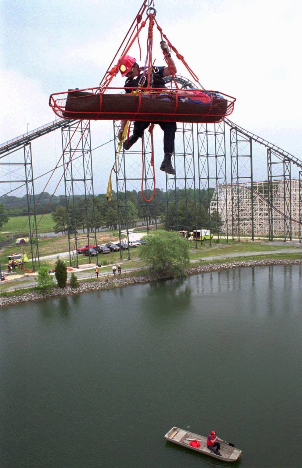 Wendy Wagner is transported across the lake at Paramount’s Kings Dominion’s Anaconda ride by Henrico firefighter Larry Bourne Wednesday, May 17, 1995, during a practice rescue.