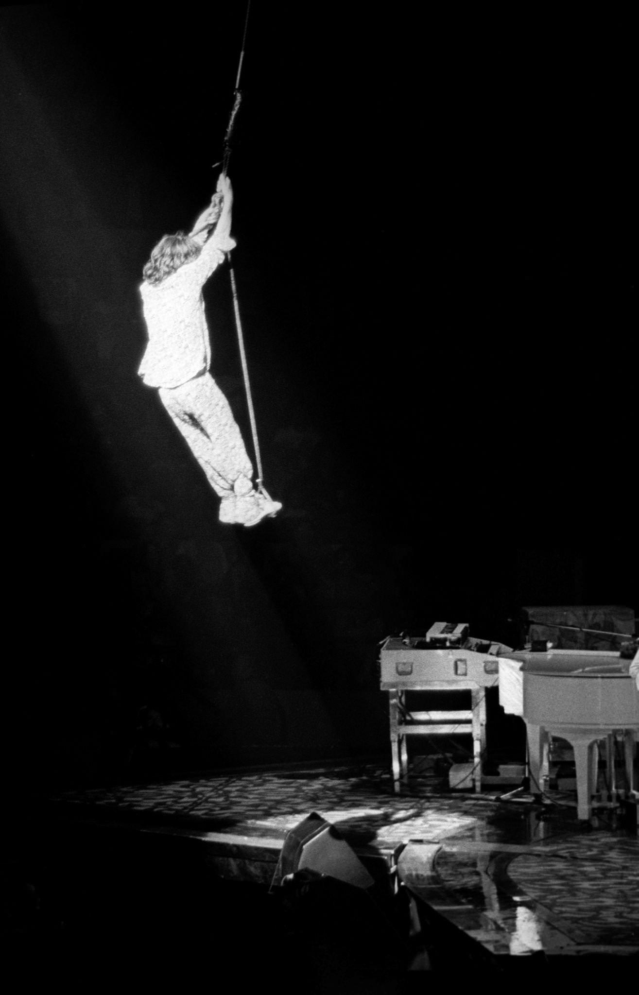 Mick Jagger swings over the crowd at Madison Square Garden during the band’s “Tour of America ’75” on June 25, 1975, in New York, New York.