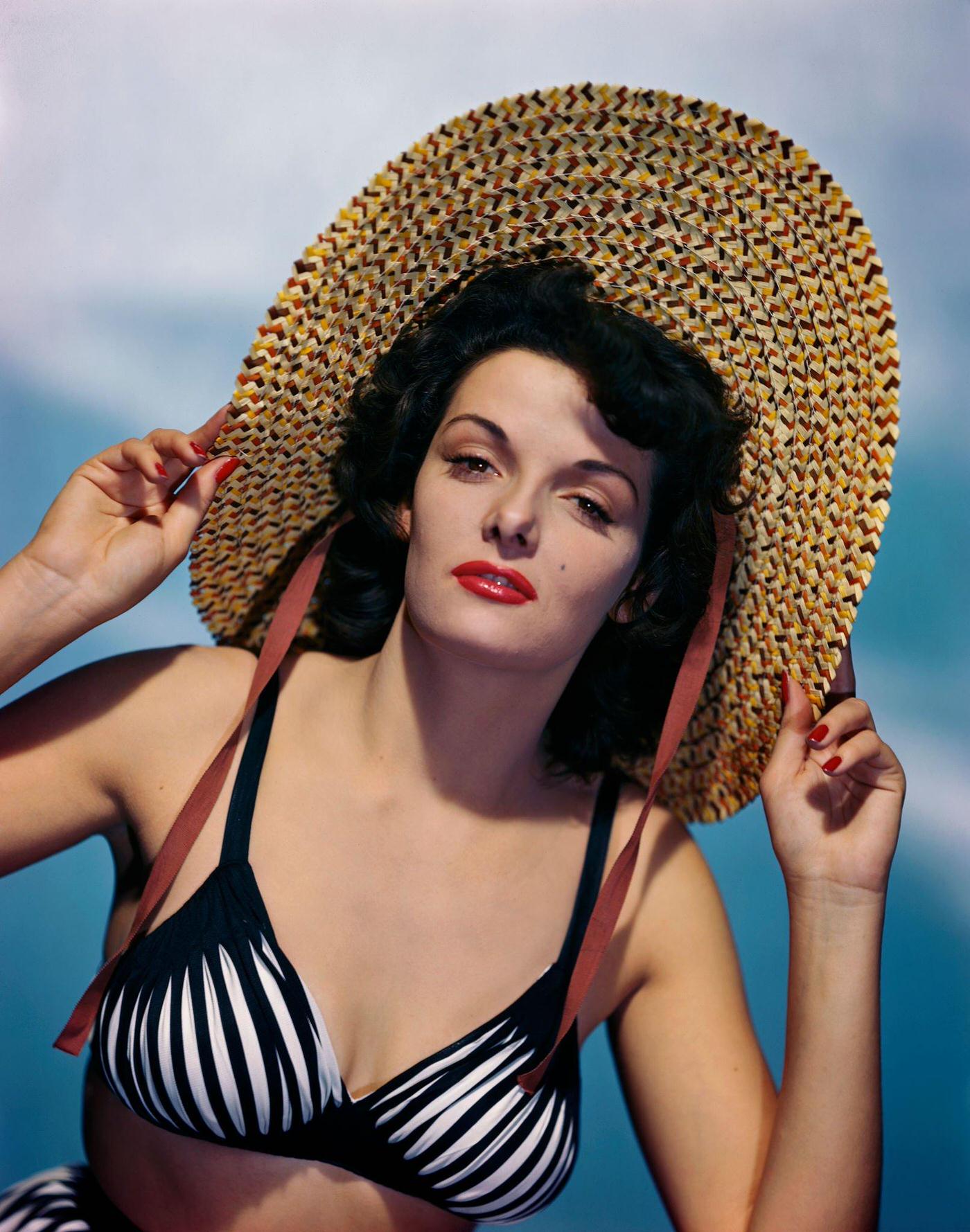 #10 Jane Russell wearing a bikini and straw hat