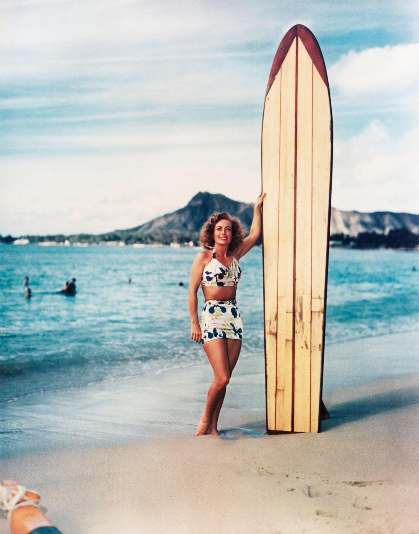 #11 Joan Crawford holding a large surfboard