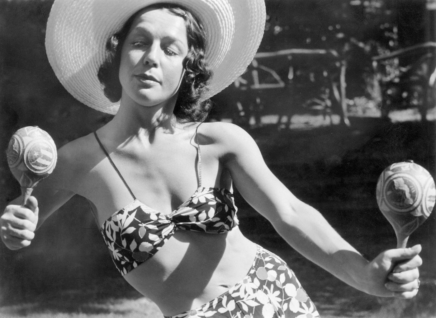 #17 Ilse Meudtner, dancer, Germany, posing in a bikini with a straw hat and rattles