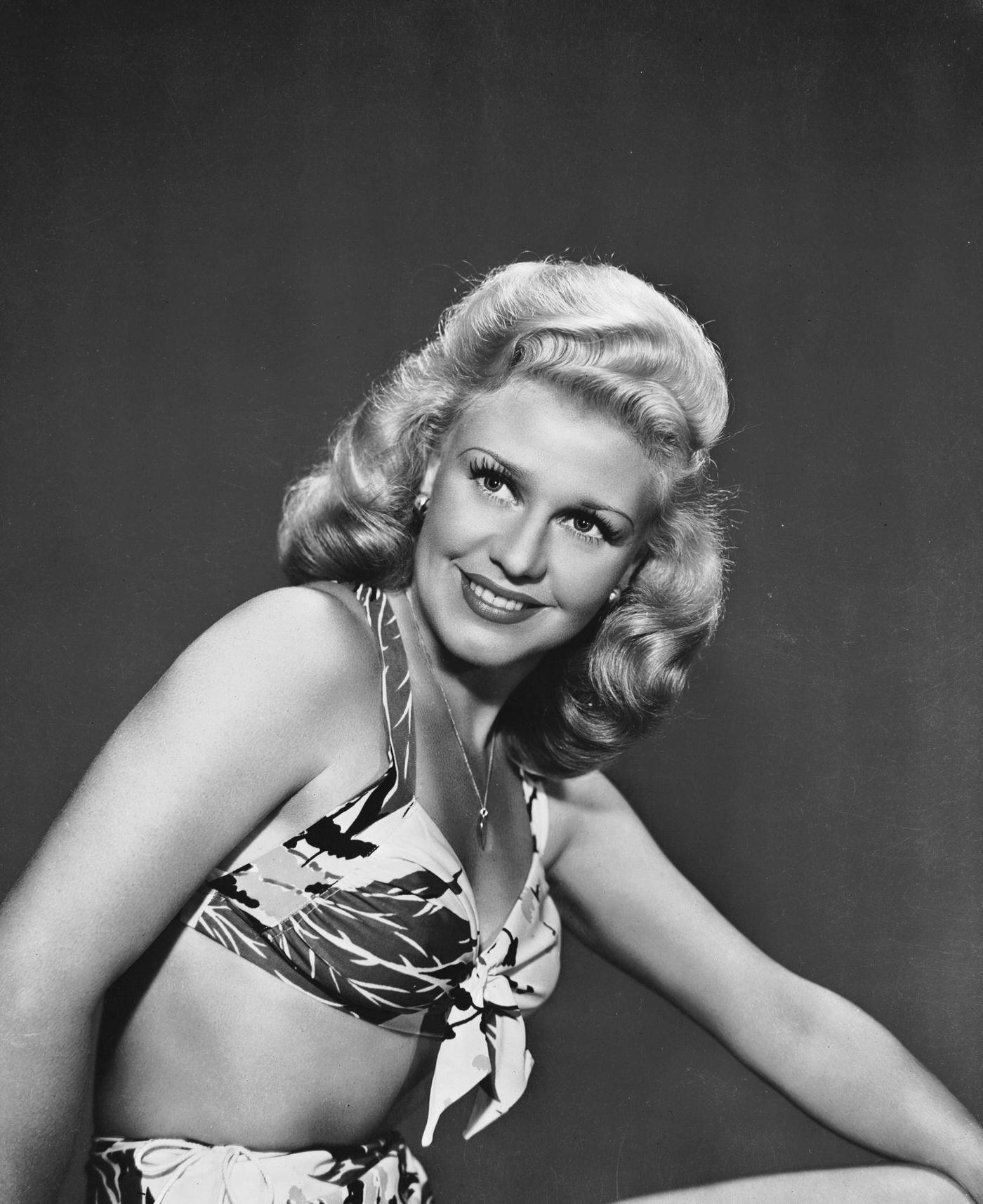 #25 Ginger Rogers, American dancer and actress, wearing a loud patterned bikini, 1944.