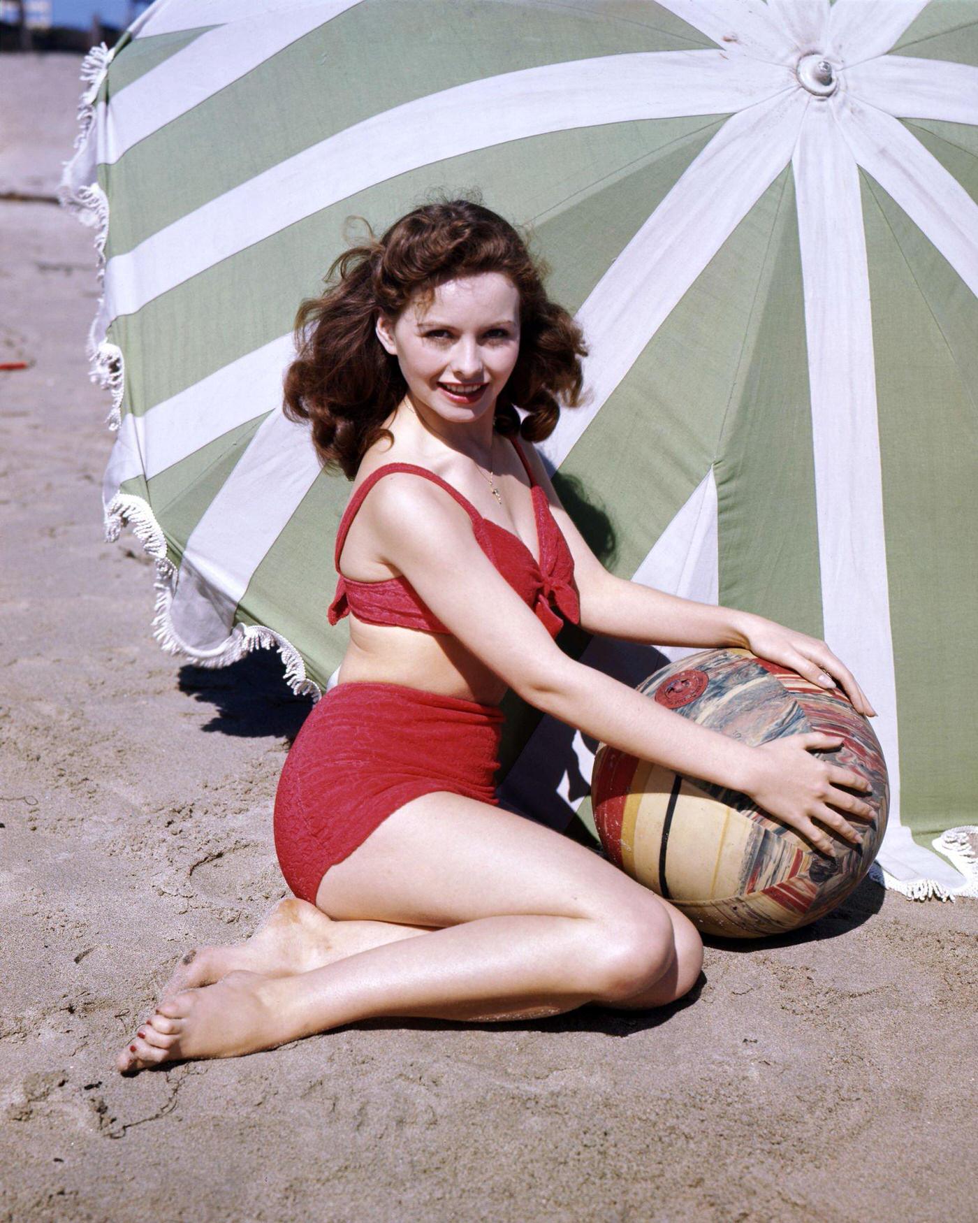 #35 Jeanne Crain at the beach wearing a bikini, 1945.