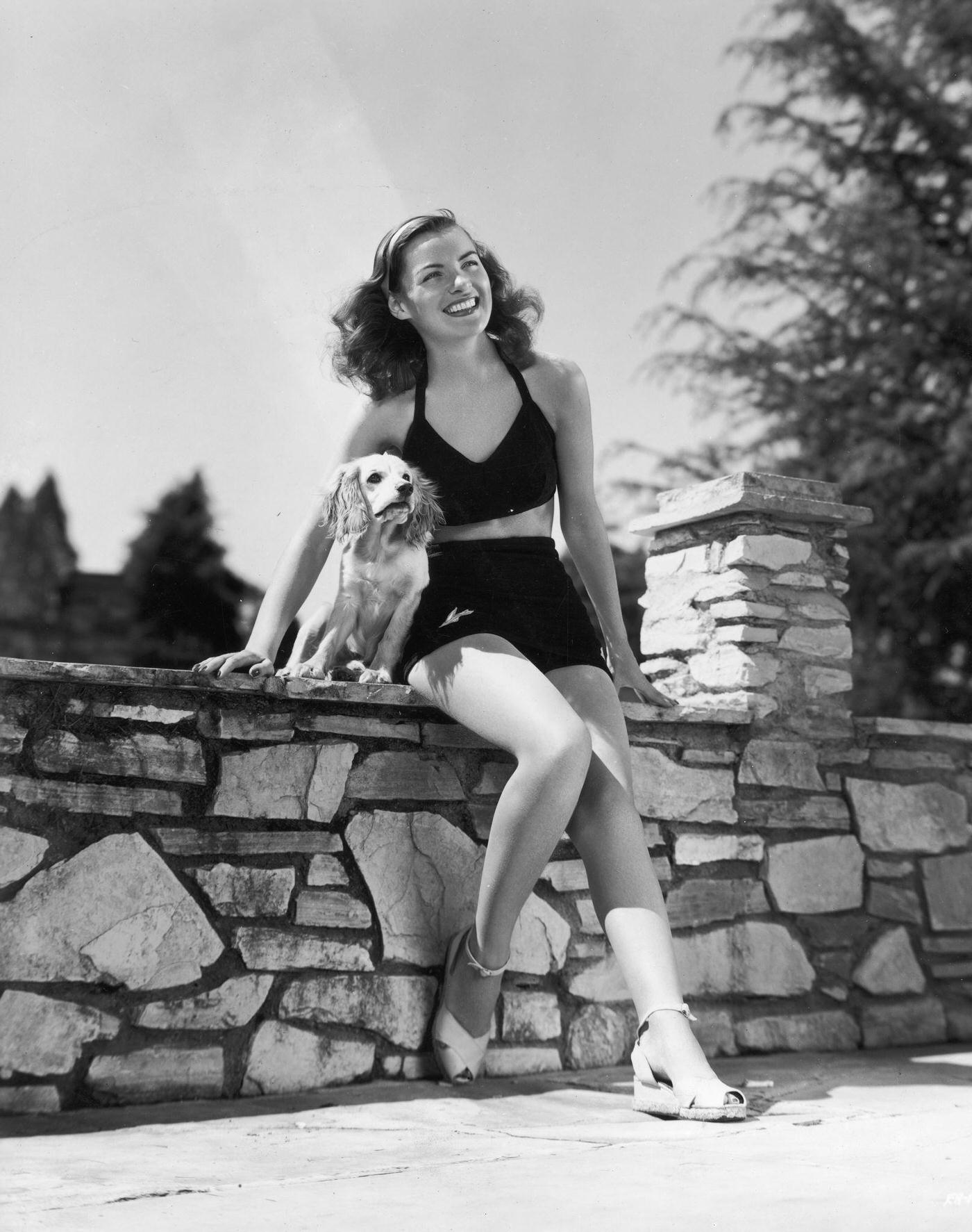#38 Ella Raines with her pet cocker spaniel Poochie, 1945.