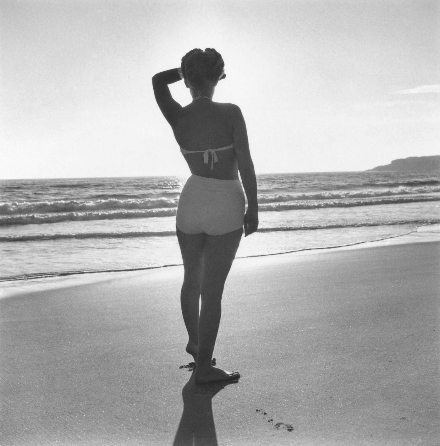 #45 Marilyn Monroe posing on a beach in a two-piece swimsuit, Malibu, California, 1946.