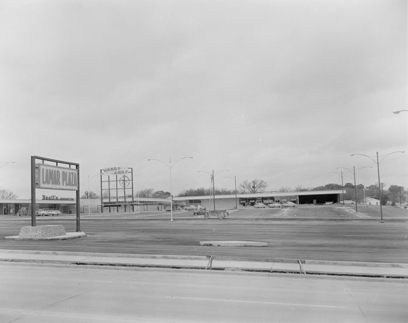 #47 Lamar Plaza Parking Lot and Stores in Background, 1958.