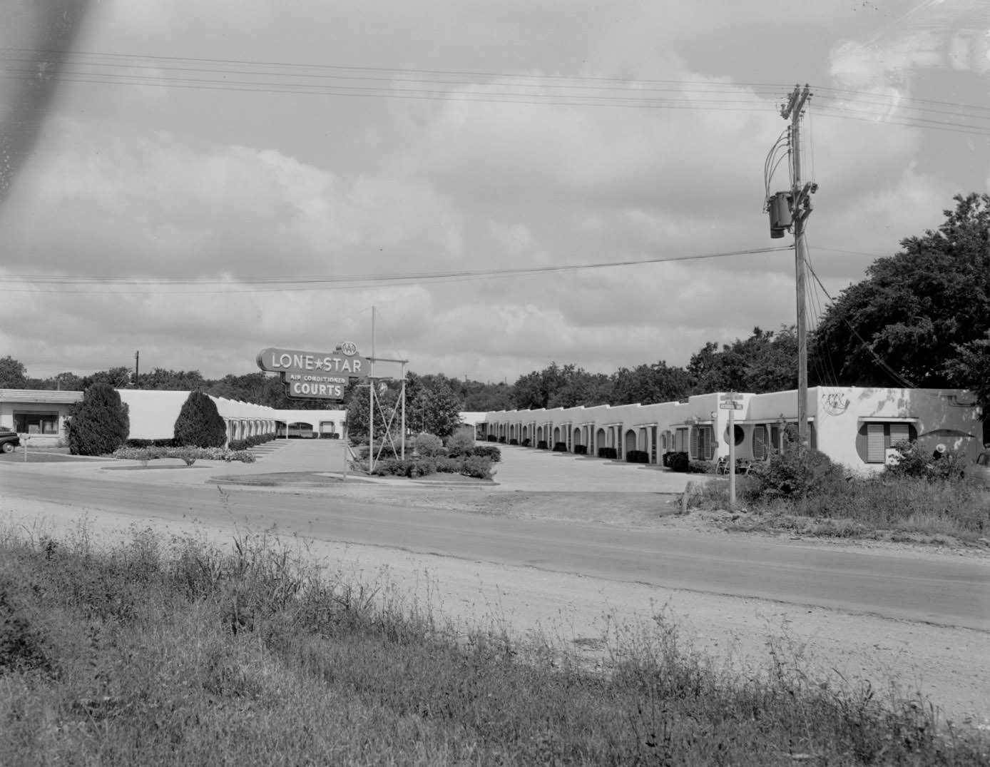 #57 Exterior of Lone Star Courts Motel with Sign, 1954.