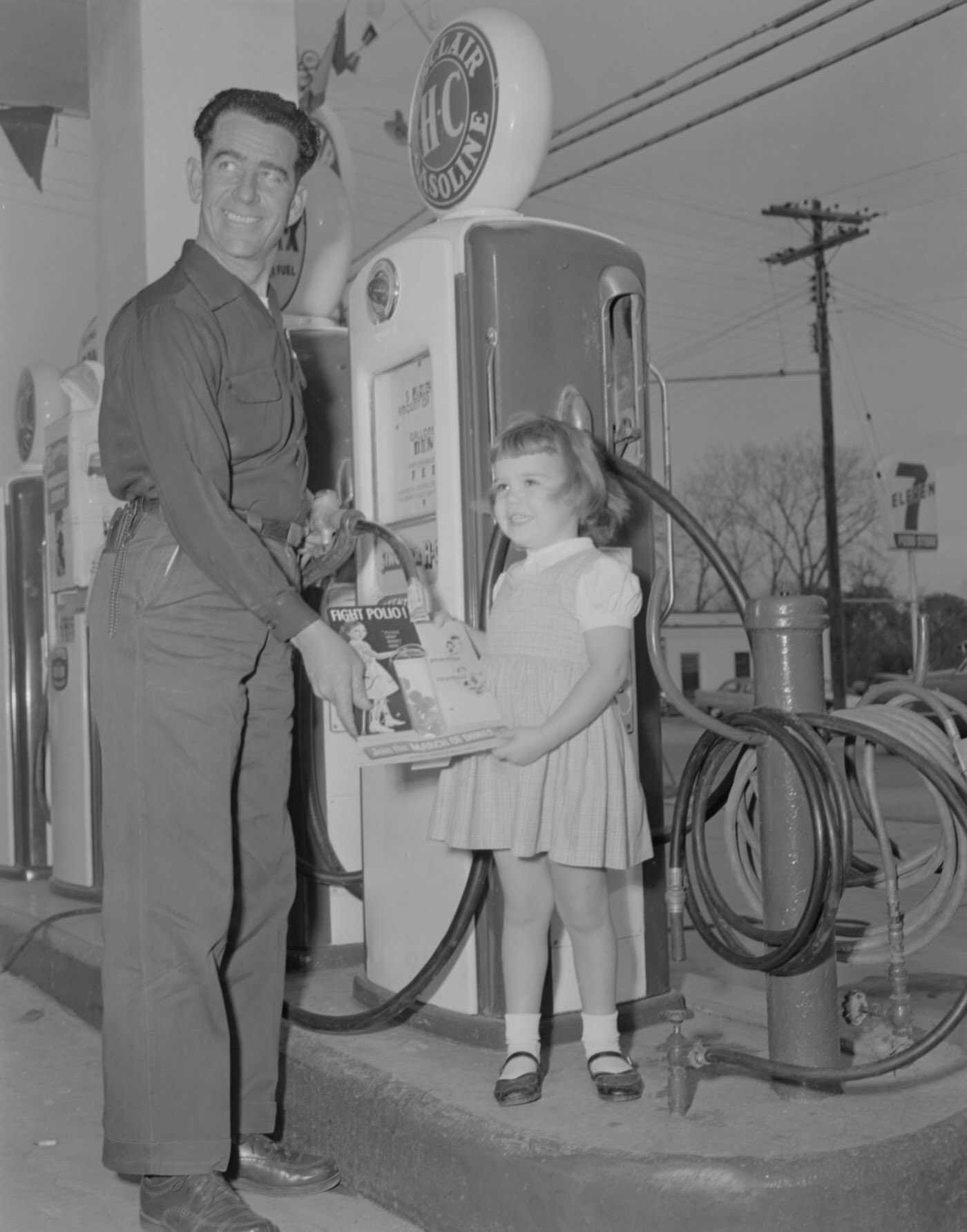 #60 Man and Young Girl at Gas Pump with March of Dimes Magazine, 1956.