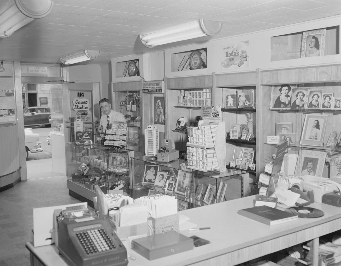 #77 Mr. O’Connor at Cameo Studios Surrounded by Photographs, 1954.