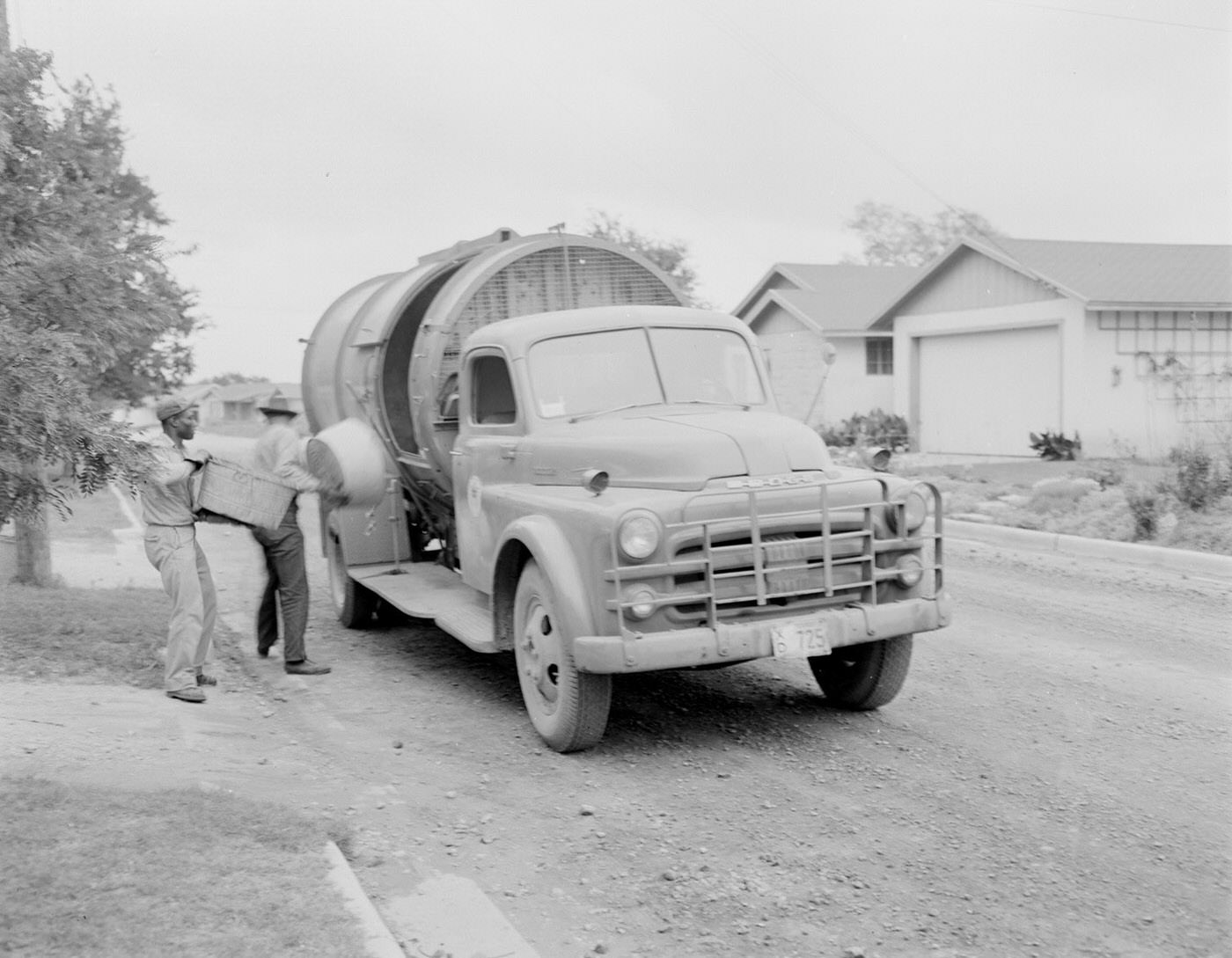 #97 Sanitation Workers Emptying Containers into Truck, 1953.