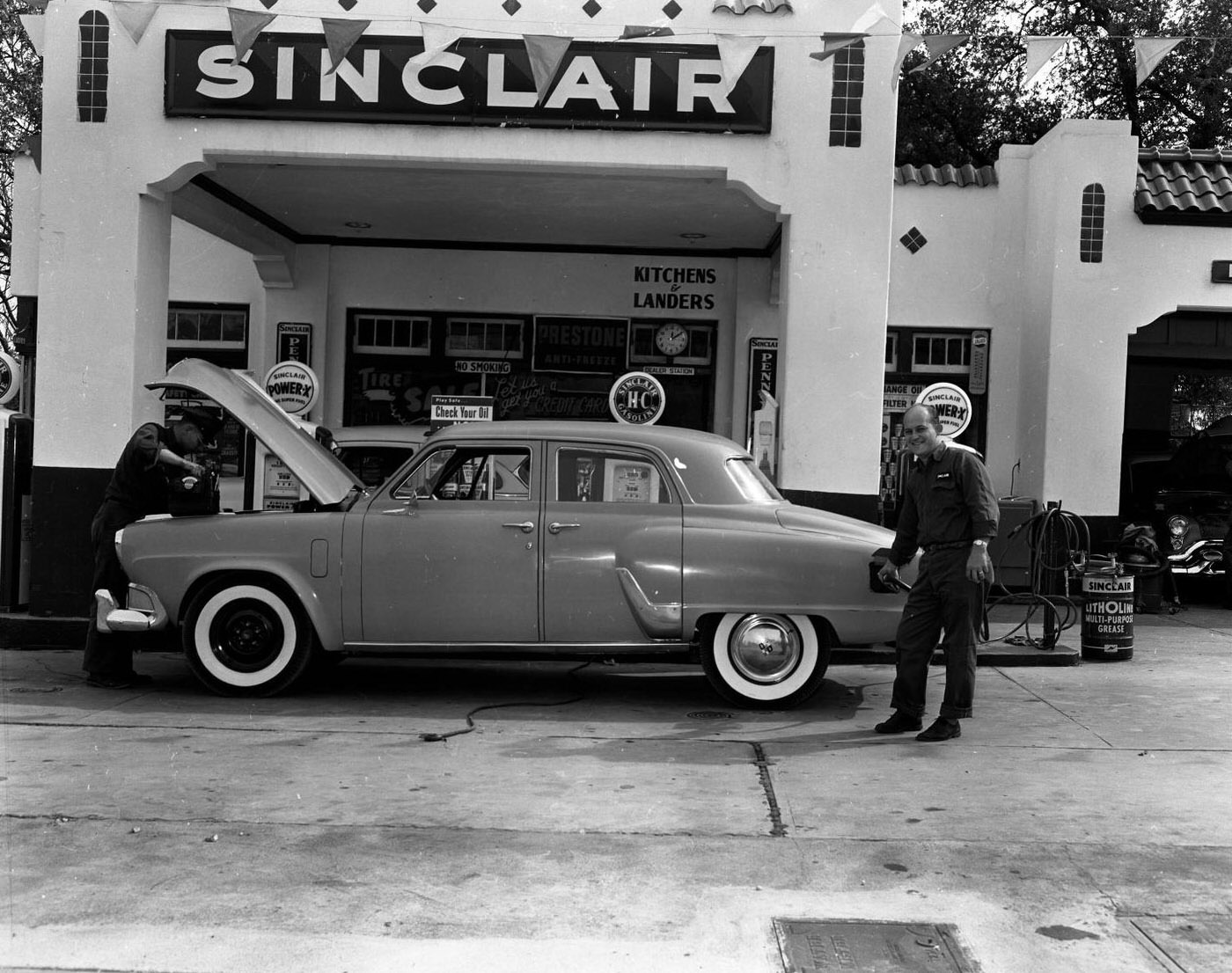 #106 Attendants at Sinclair Service Station, 1955.