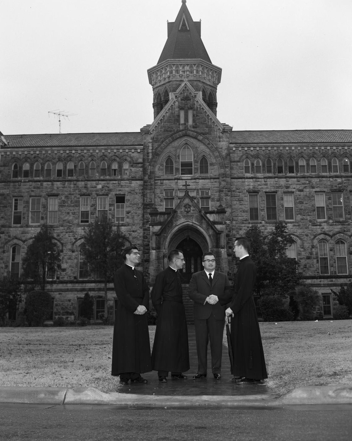 #125 Man Discusses with Priests at US Information Agency, St. Edward’s University, 1959.