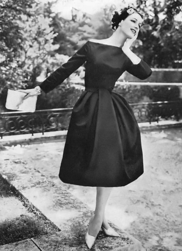 #11 Betsy Pickering in black satin cocktail dress by Nina Ricci, 1957