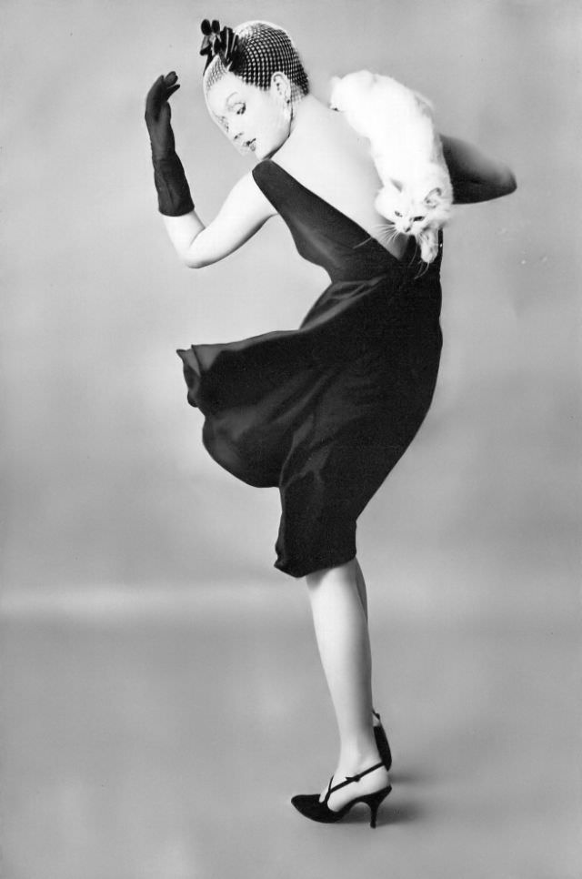 #21 Betsy Pickering in black rayon-crêpe dinner/theatre/dance dress by Lee Claire, 1959