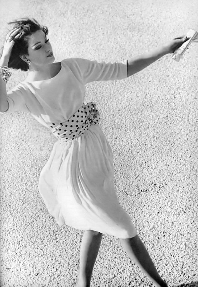 #25 Betsy Pickering in white crêpe dress with satin polka-dots by Charles Dickey, 1959